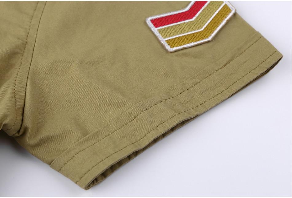 Close-up of military shirt sleeve featuring a colorful badge in red and yellow, highlighting detail and style.