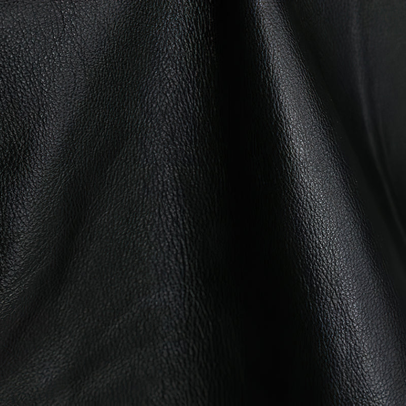 Close-up of genuine black leather fabric showcasing texture, ideal for biker and punk style vests.