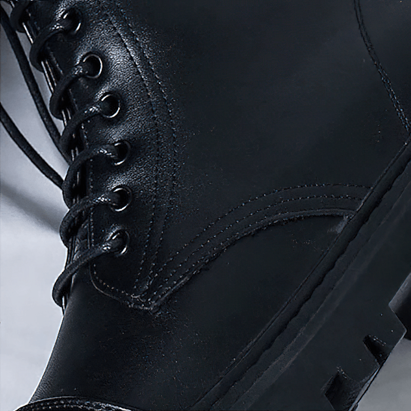 Close-up of men's black lace-up ankle boots featuring quality PU leather and a comfortable rubber sole.