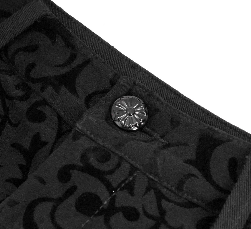 Close-up of black button on stylish gothic leggings featuring intricate fabric pattern.