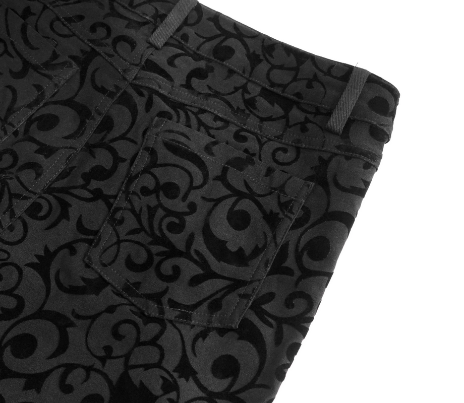Close-up of black leggings featuring intricate gothic floral patterns and side pockets, perfect for stylish outfits.