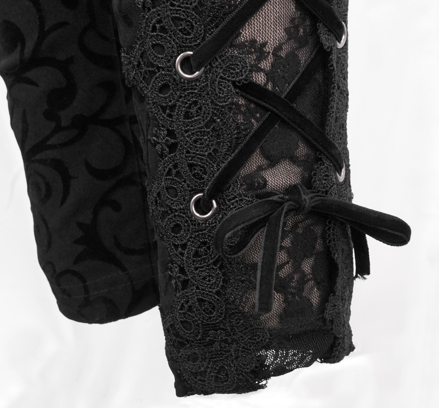 Close-up of black leggings featuring Gothic lace and side lacing, showcasing stylish detail and ornate design.