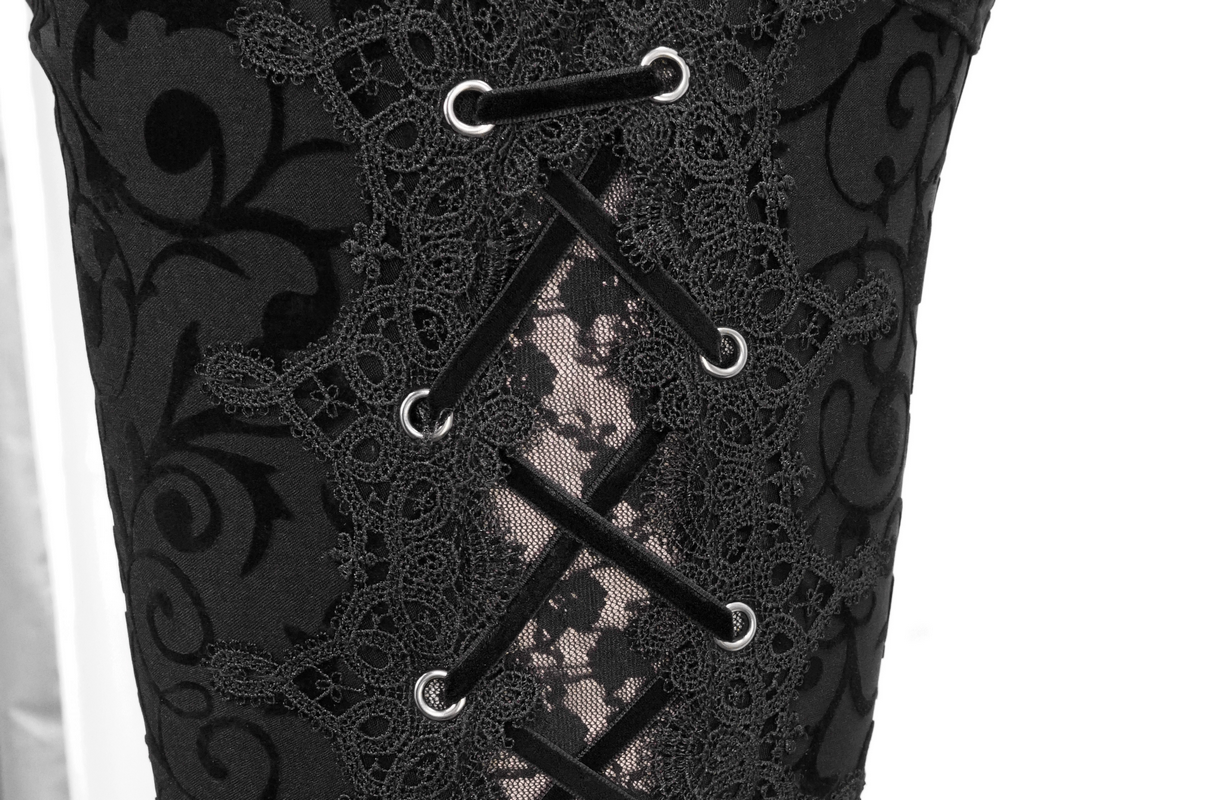 Close-up of gothic black leggings with intricate lace and drawstring details on the side.