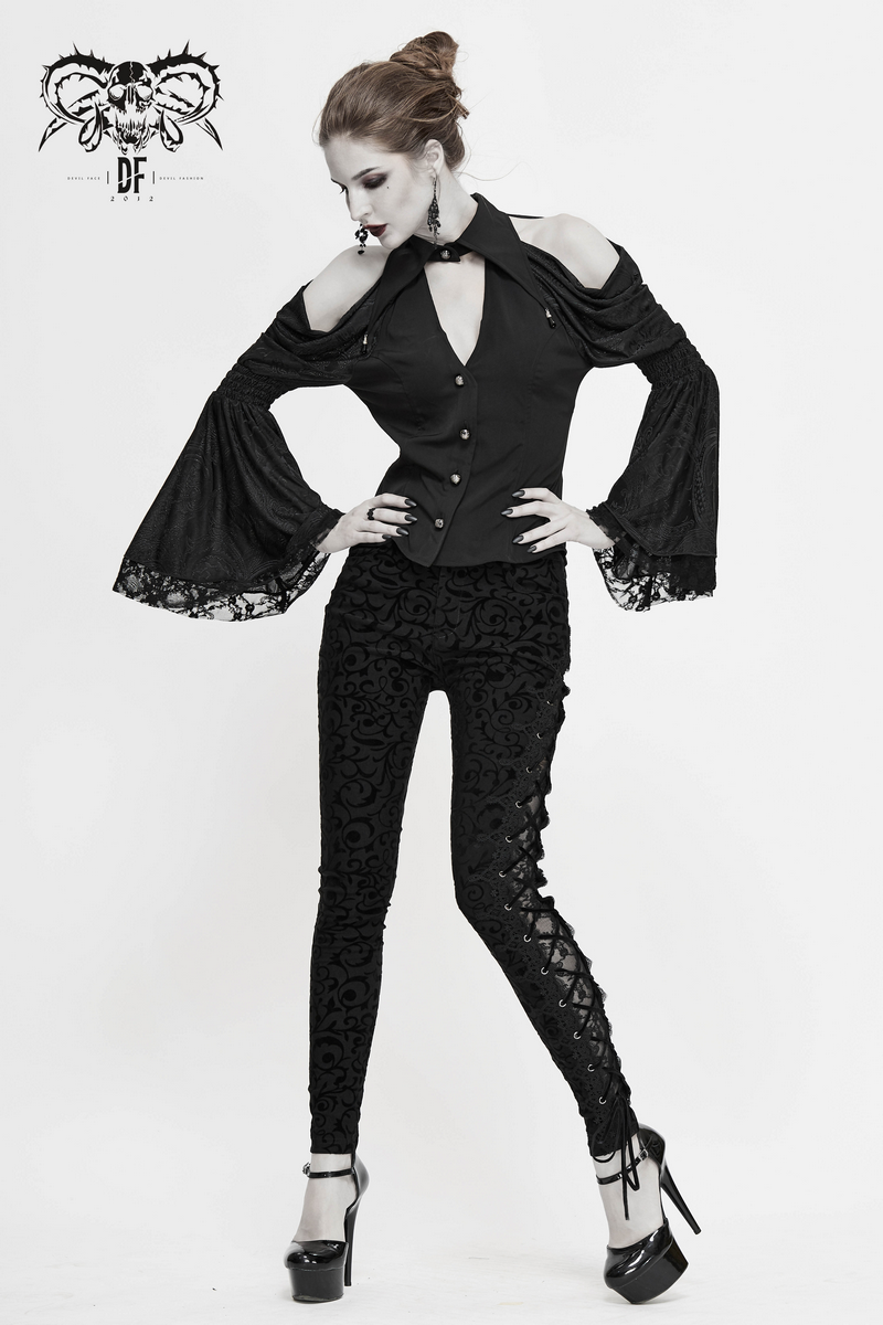 Stylish woman in gothic black leggings with side lacing, paired with an elegant cold-shoulder top and high heels.