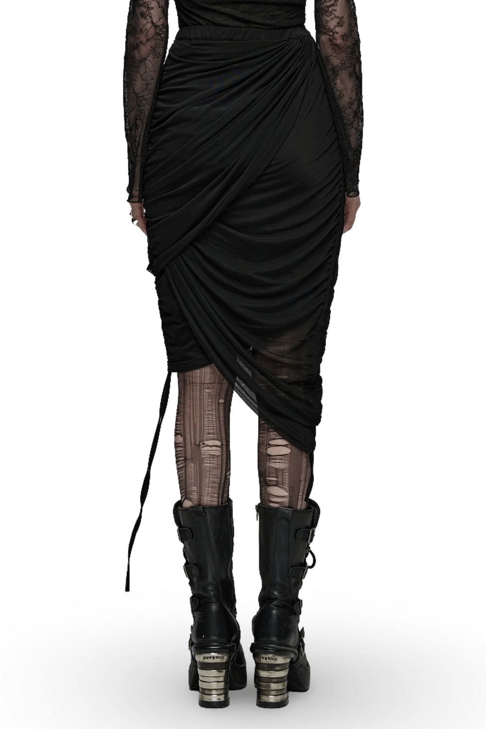 Back view of a convertible black skirt with draped design and high-low mesh accents, paired with edgy black boots.