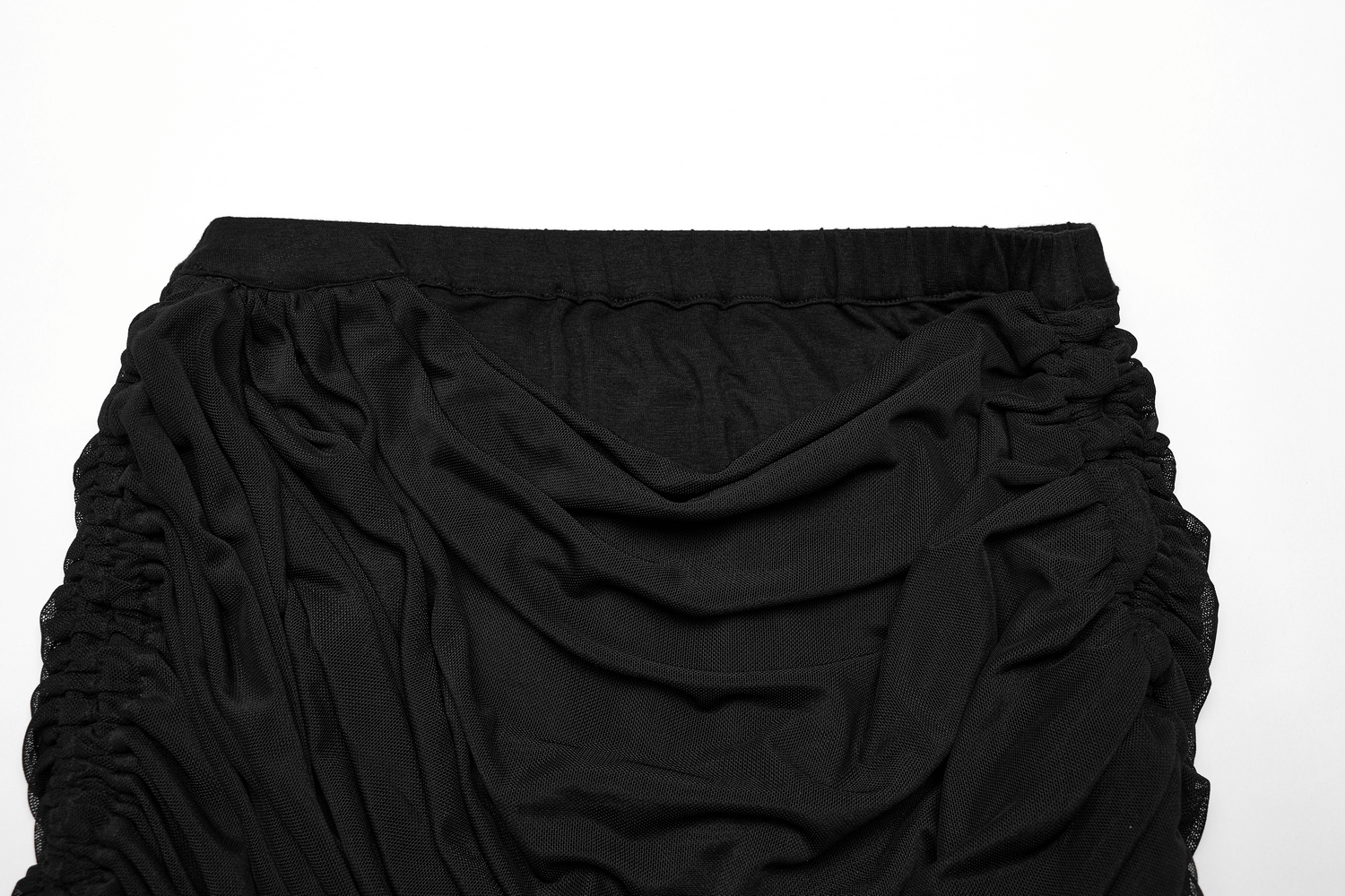 Close-up of a black convertible pleated mesh skirt showcasing its elegant draping and unique wrap design.