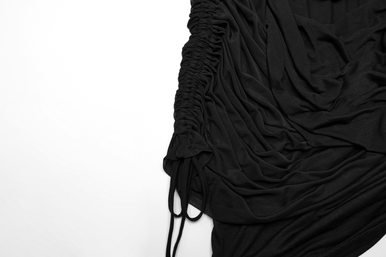 Close-up of a black convertible pleated mesh skirt showcasing its drapey fabric and unique wrap design.