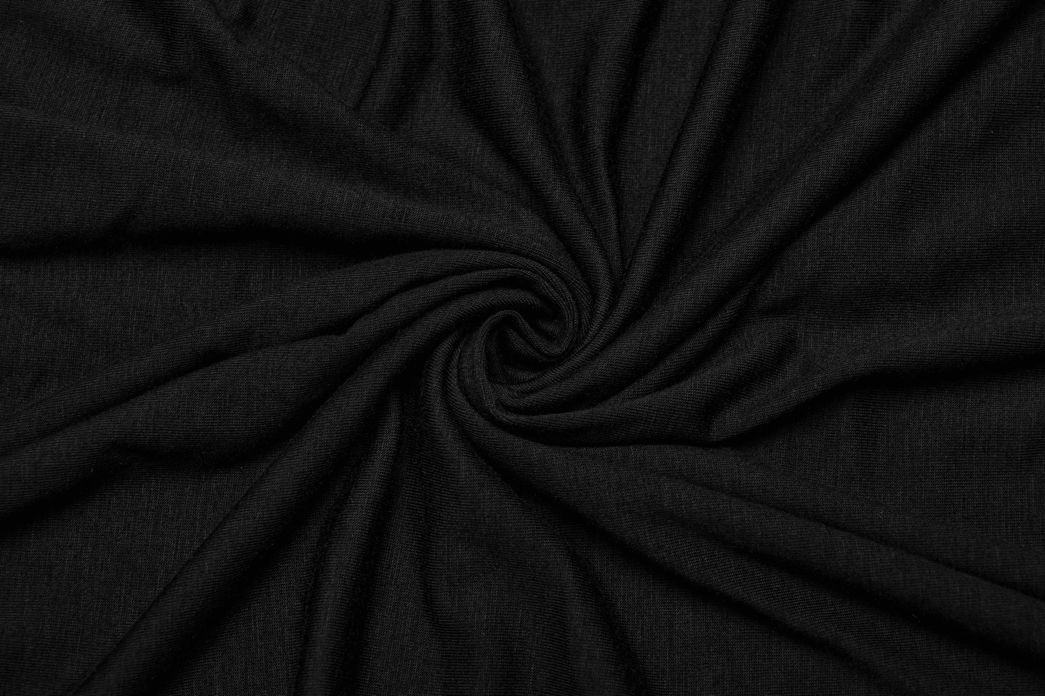 Soft black fabric in a spiral pattern, showcasing the elegant texture of the convertible pleated mesh skirt.