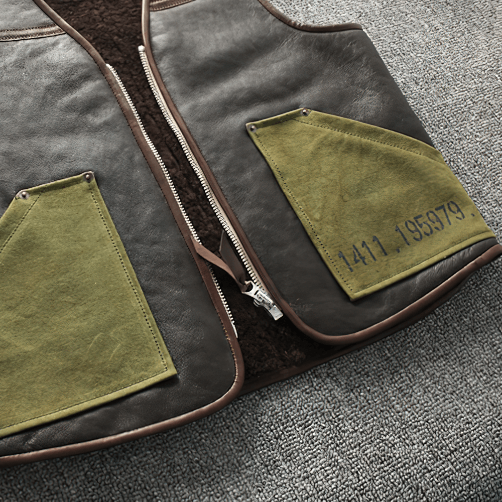 Men's black leather biker vest featuring stylish green pockets, perfect for vintage-inspired motorcycle attire.