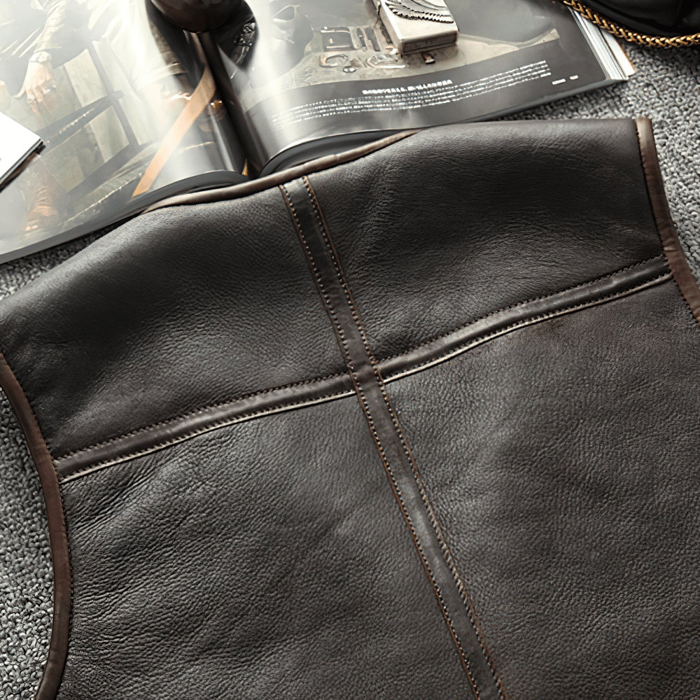 Close-up of a black leather biker vest with vintage detailing, showcasing the quality craftsmanship and design.