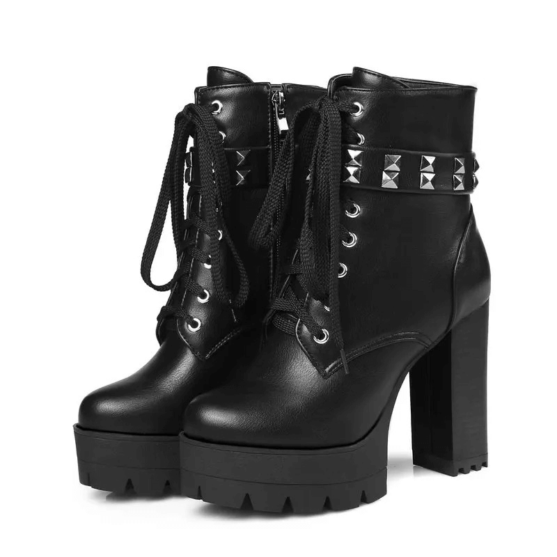 Stylish women's high-heeled winter boots with rivets, laces, and chunky rubber soles in black.