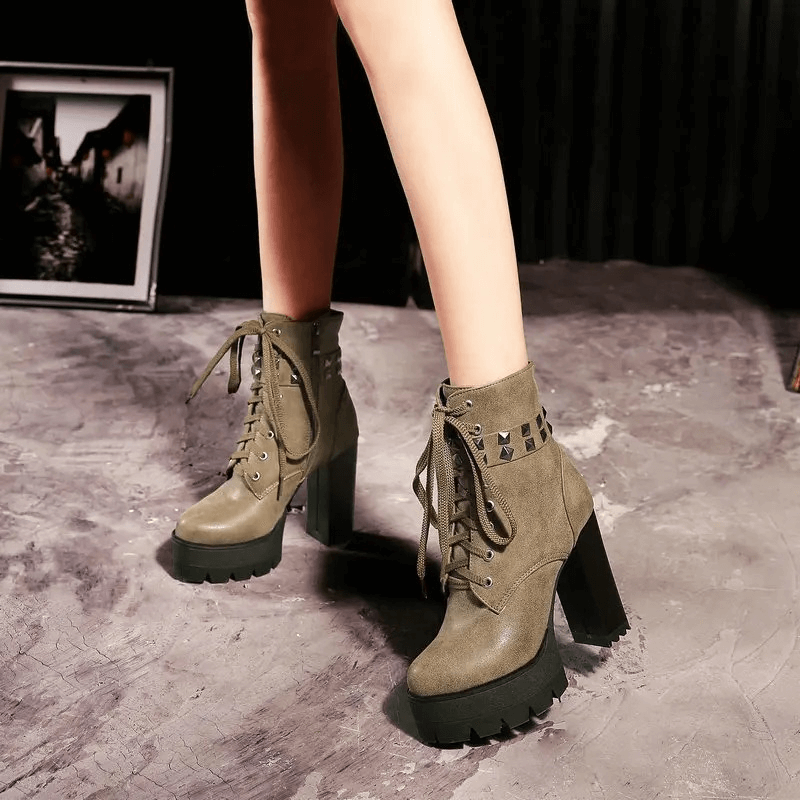 Stylish women's winter boots with heels, featuring rivets and laces for a rock-inspired look.