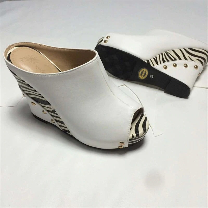 Stylish white wedge sandals with zebra print, perfect for summer fashion and elevating any outfit.