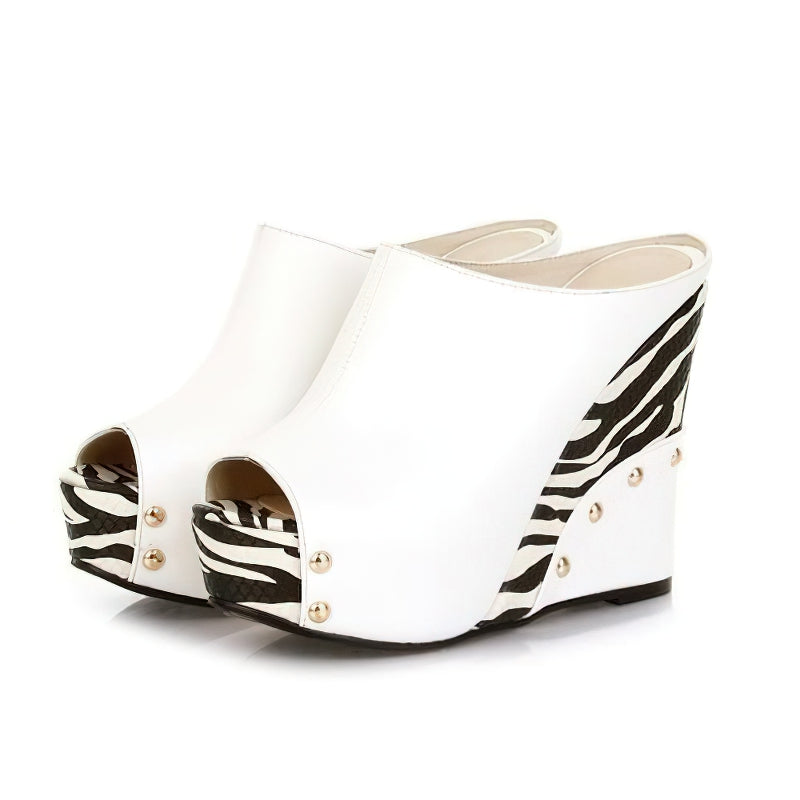 White wedge sandals with zebra print design, featuring peep toe and stylish studs, perfect for summer fashion.