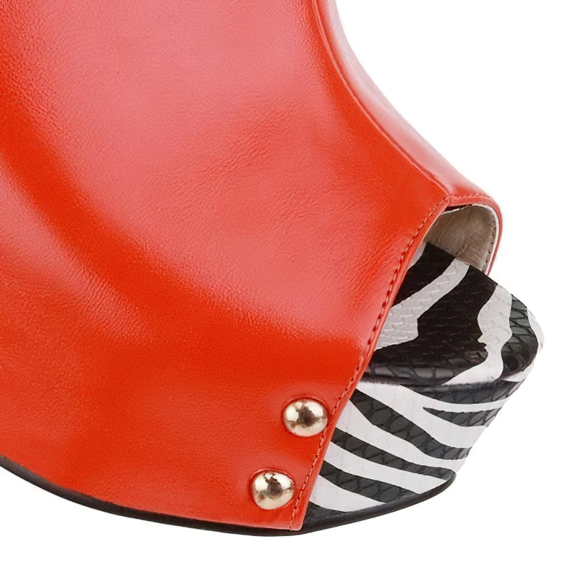Close-up of stylish orange high heel sandals with a zebra print platform, perfect for summer fashion.