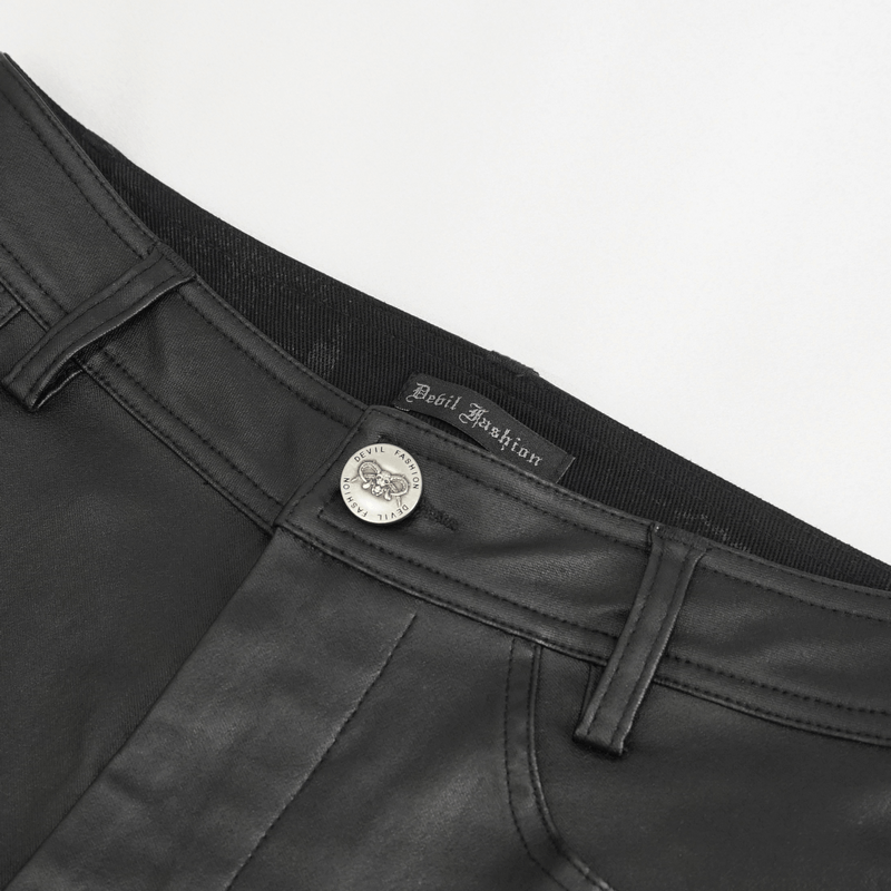 Close-up of women's black multi-buckle splice pants showcasing the label and button detail for a stylish punk look.