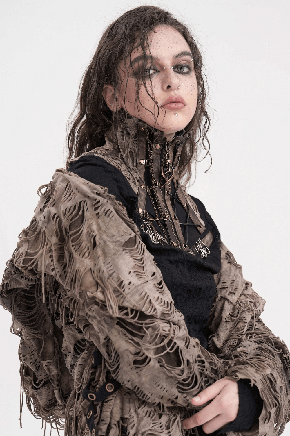 Gothic corset neckwear with chains and distressed design, styled with a layered, textured wrap. Perfect for alternative fashion.