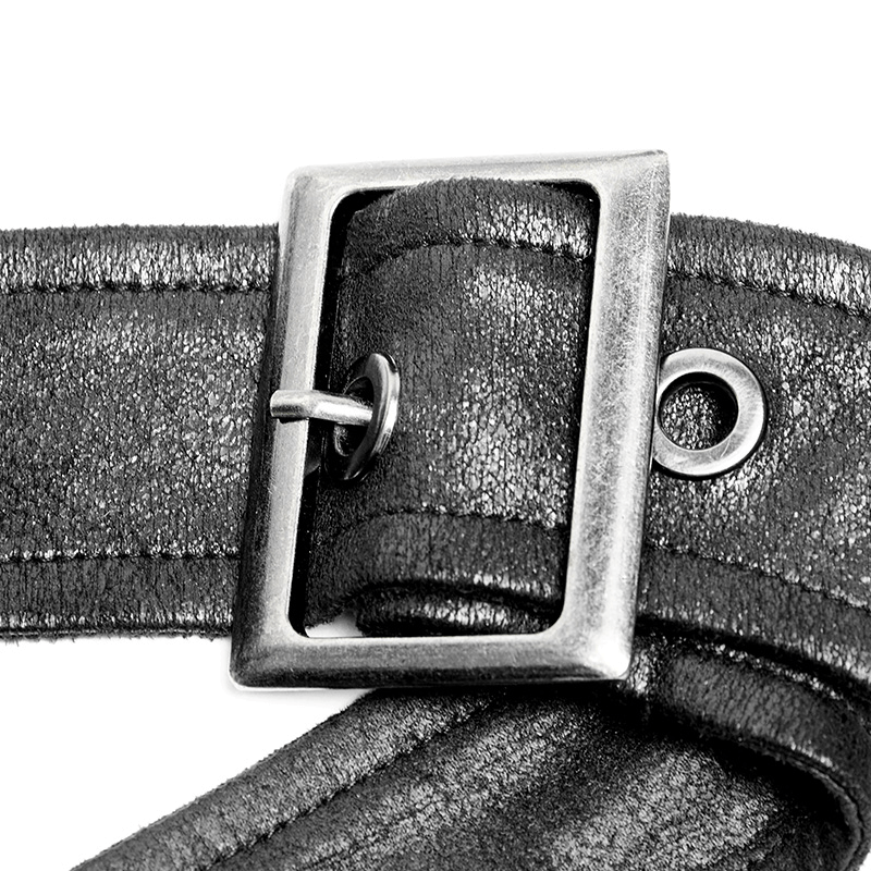 Close-up of a metallic buckle on a leather strap, showcasing a sleek design and adjustable features.