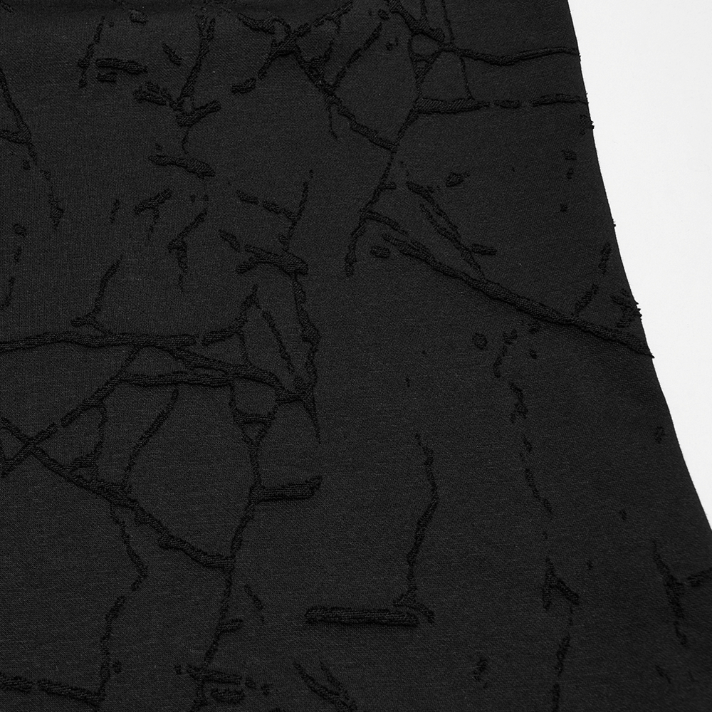 Close-up of cracked texture on a hooded punk T-shirt in black, showcasing edgy knitted design.