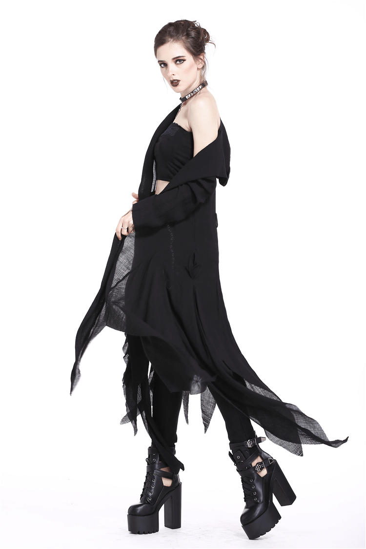 Model wearing a crescent moon shredded gothic punk long hoodie trench coat with dramatic oversized hood and platform boots.