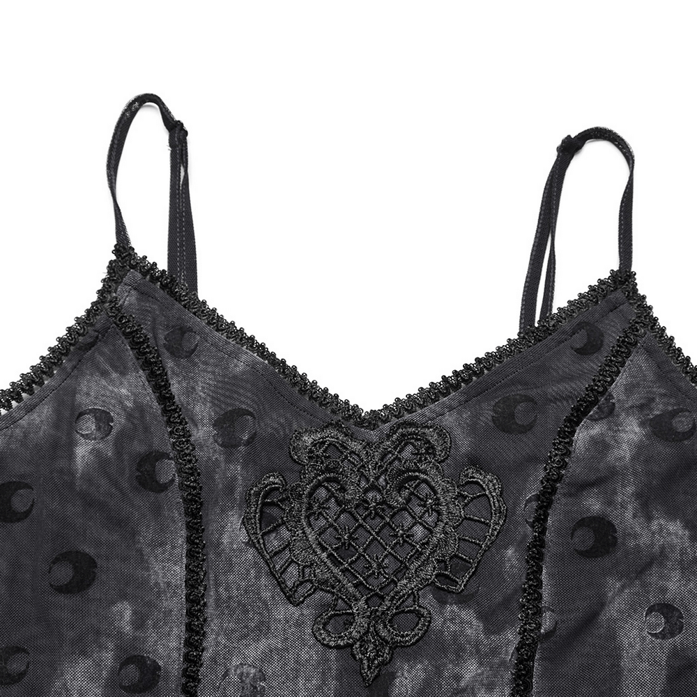 Close-up of crescent print dress neckline featuring lace and heart embroidery details.