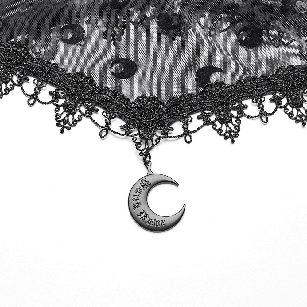 Close-up of layered gothic mesh with crescent moon pendant and lace details, perfect for ethereal fashion lovers.