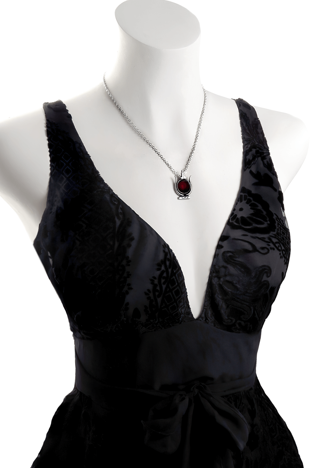 Cult of Aset Egyptian goddess pendant with red enamel showcased on a stylish black dress.