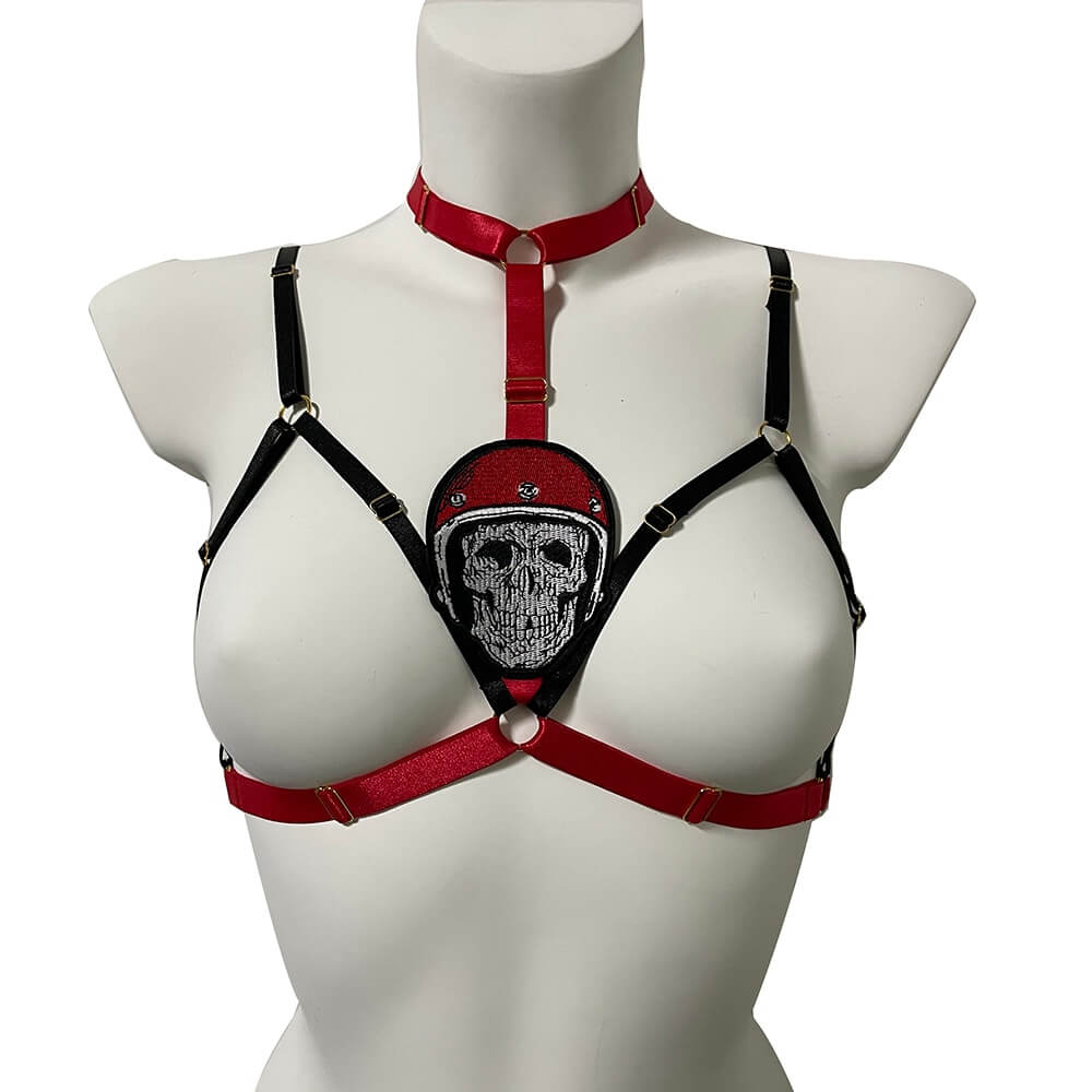 Cupless elastic body harness for women featuring skull detail, combining gothic and erotic styles.