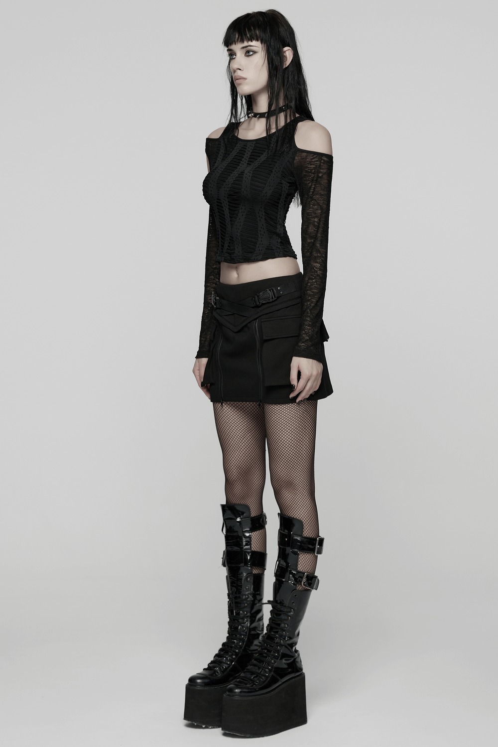 Cut Out Knit Top with Hollow Sleeved Design for Women worn with a mini skirt and platform boots, showcasing edgy punk style.
