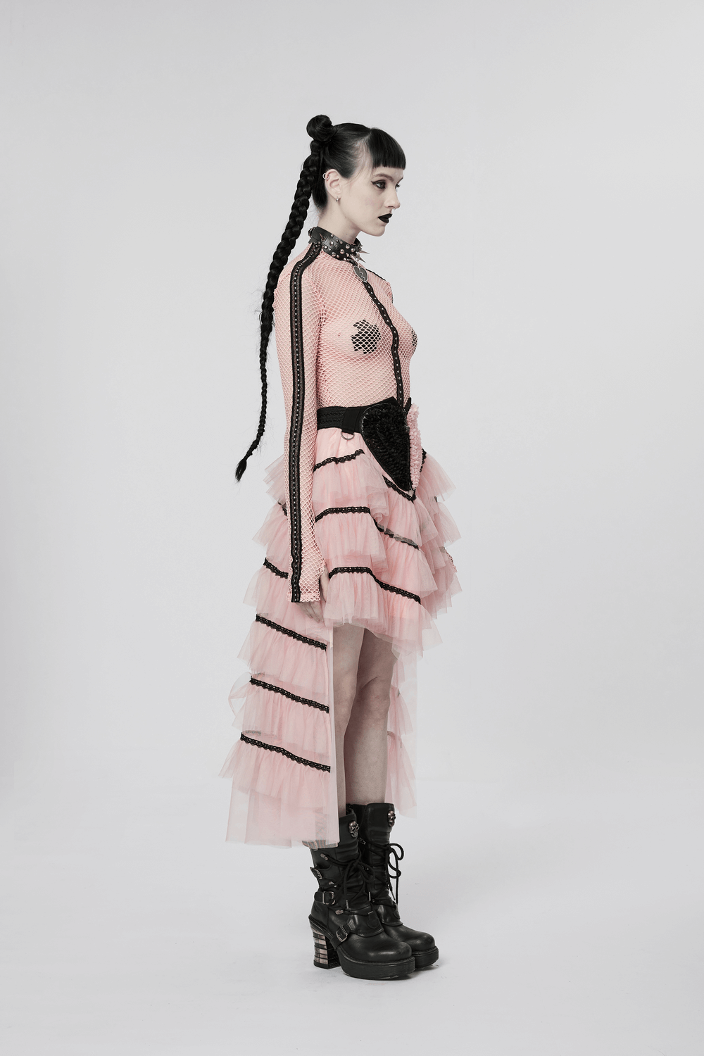 Punk girl in a pink ruffled mesh skirt with skeleton hand zipper, showcasing edgy style and playful rebellion.