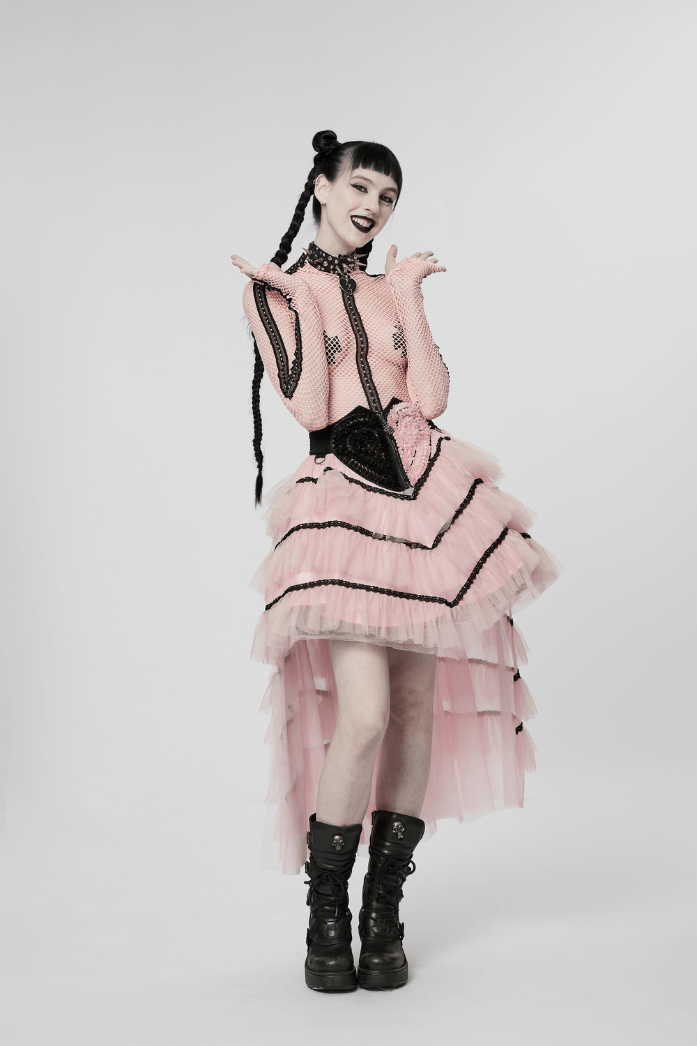 Punk girl in pink ruffled mesh heart skirt, stylishly rocking black accessories and edgy boots. Perfect for a cool, dark allure.