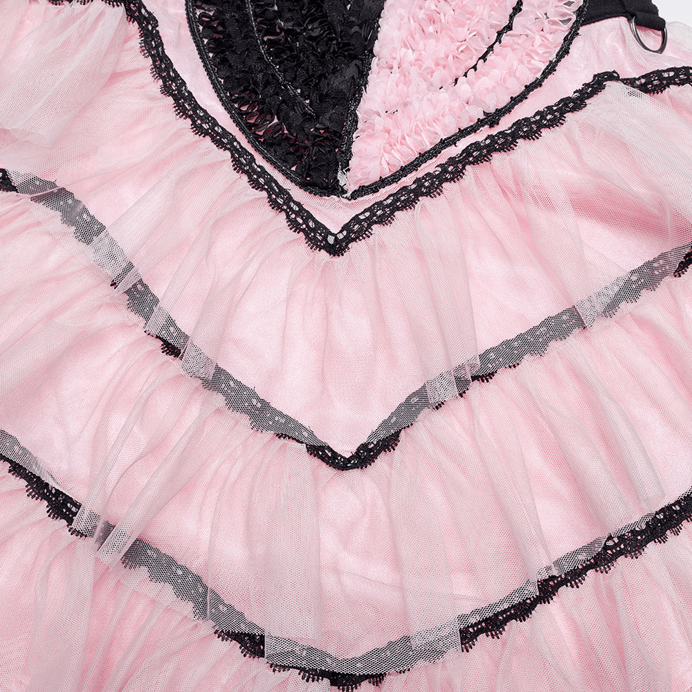 Close-up of a cute pink and black ruffled mesh skirt with lace trim, showcasing layers and heart designs for a punk look.