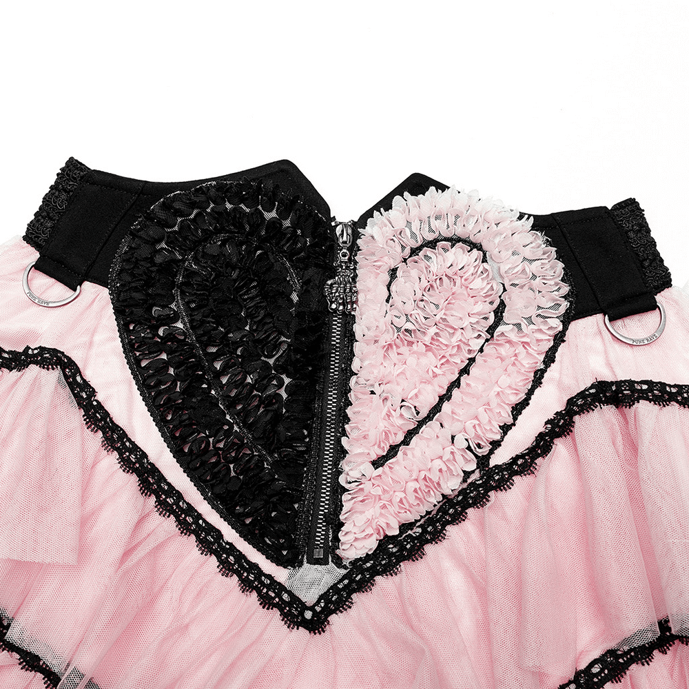 Detail of pink ruffled mesh heart skirt with skeleton hand zipper and romantic heart appliqué.