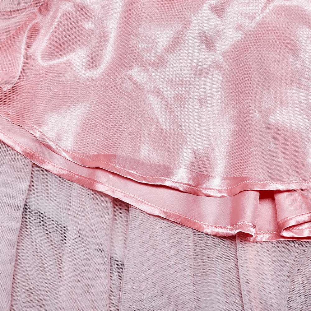 Close-up of soft pink satin and mesh layers of a punk-inspired ruffled skirt with elegant sheen.