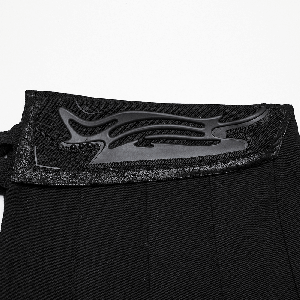 Close-up of the unique cyber 3D print and buckle on the waist of a black men's pleated half skirt.