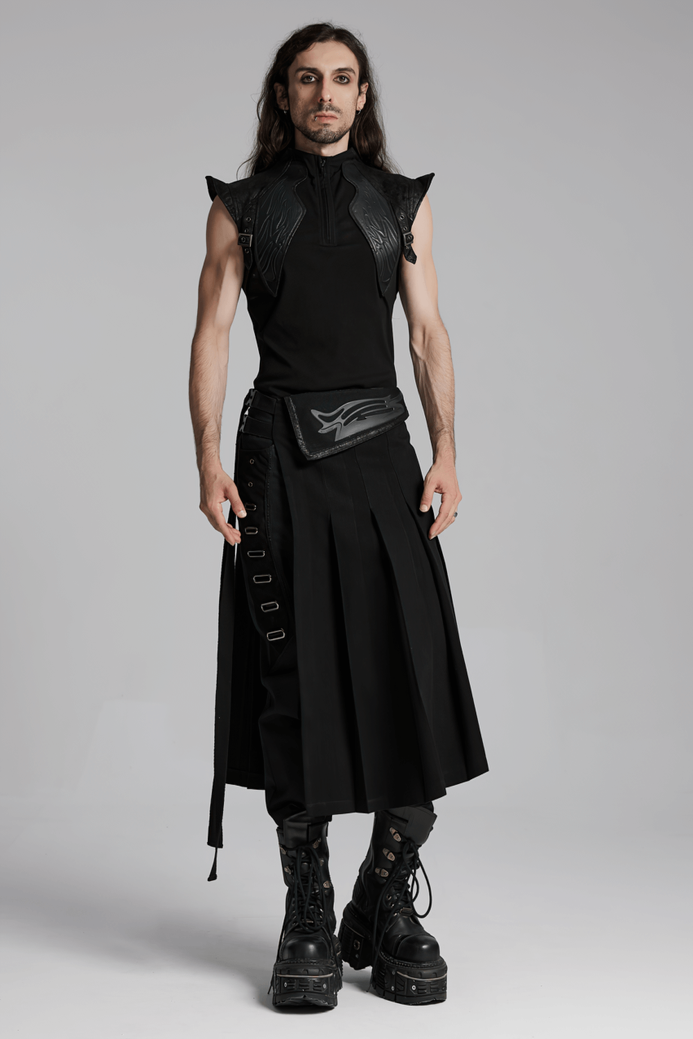 Cyberpunk black men's pleated half skirt with buckles, styled with a sleek black top and bold platform boots.