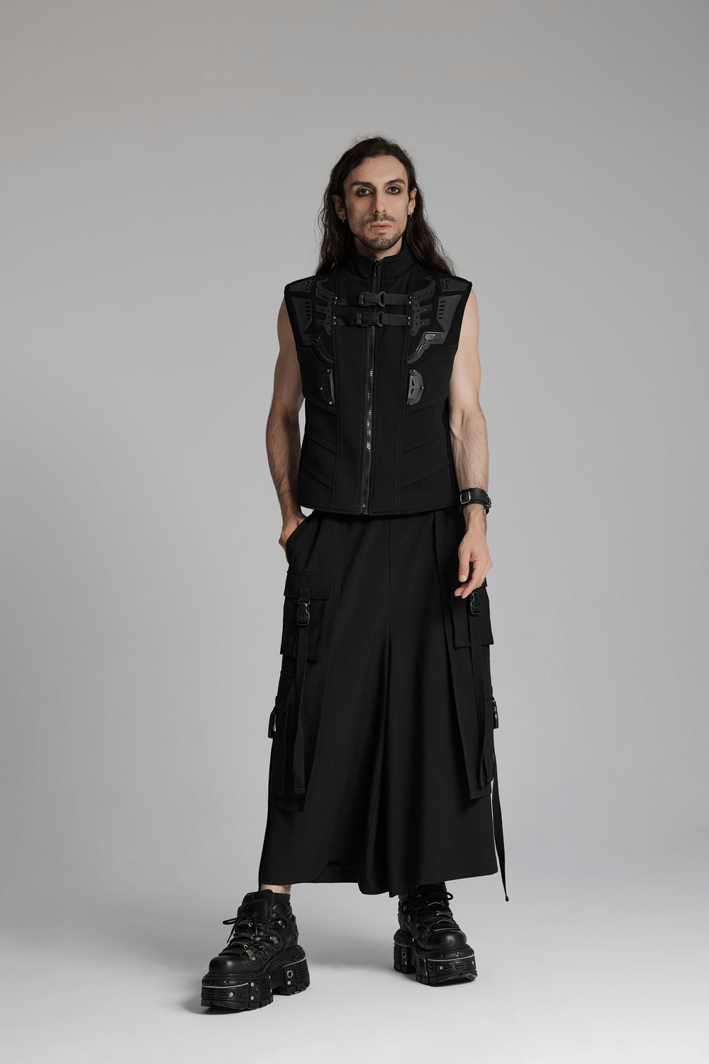 Stylish model in a black sleeveless vest and wide black pants with cargo pockets, showcasing a bold cyberpunk aesthetic.