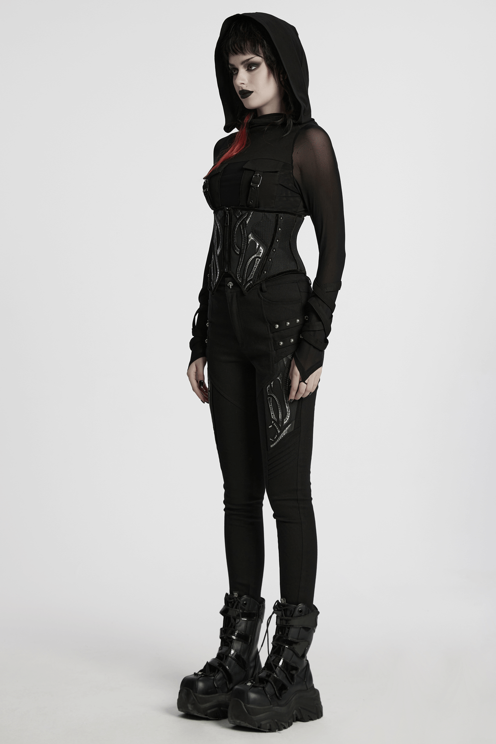Futuristic model wearing a black mesh corset belt with studs, tech details, and a hood, styled in cyberpunk fashion.