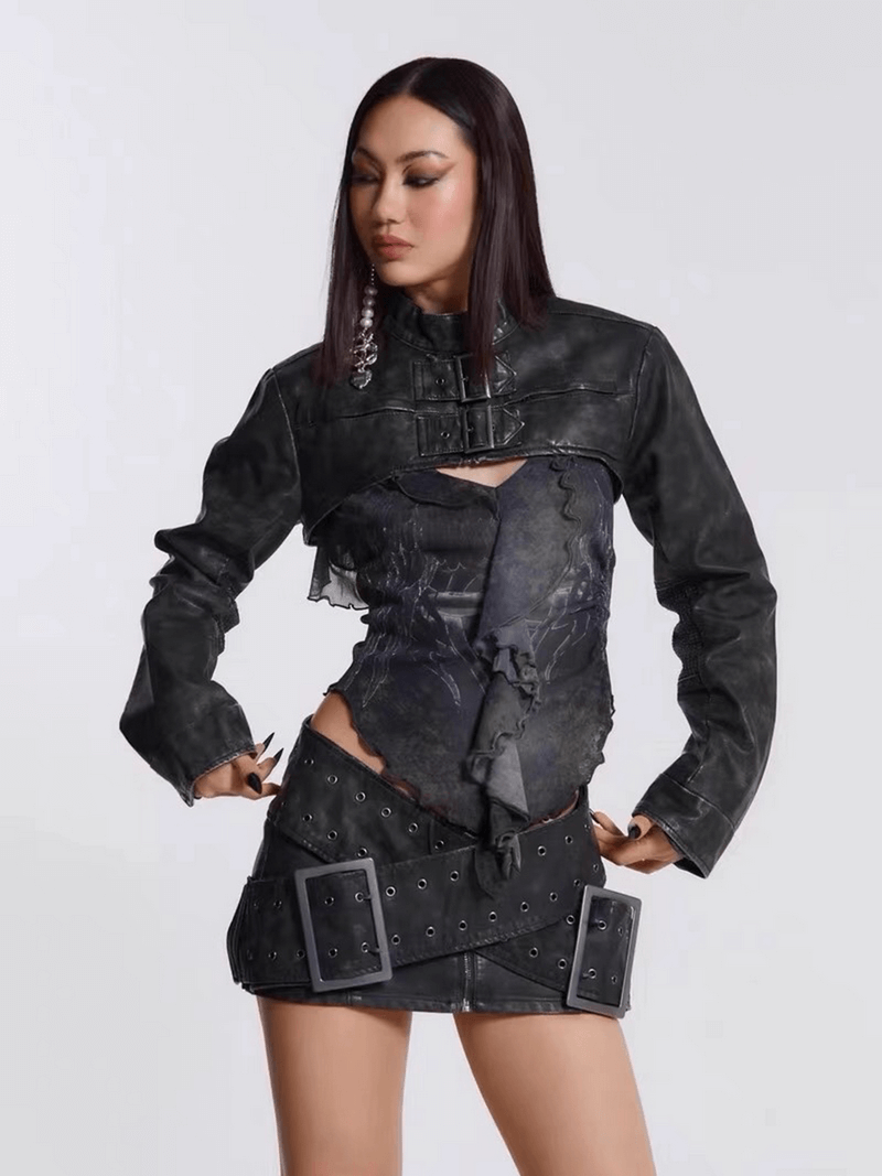 Fashion-forward woman wearing a black leather Cyberpunk cross-belt mini skirt and edgy cropped jacket.