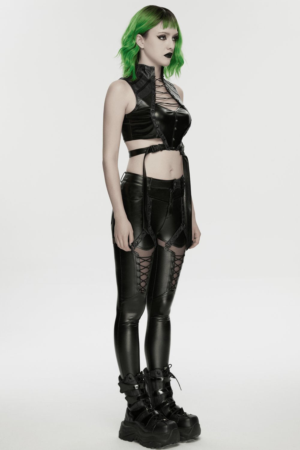 Alt Tag: Cyberpunk Faux Leather Lace Up Harness Crop Top on model in black buckle cutout gothic look, lace-up harness and straps