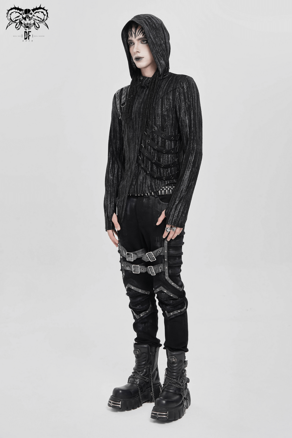 Cyberpunk Hooded Top with Straps and Asymmetric Hem worn with edgy pants and chunky boots, featuring buckles and a textured fabric.