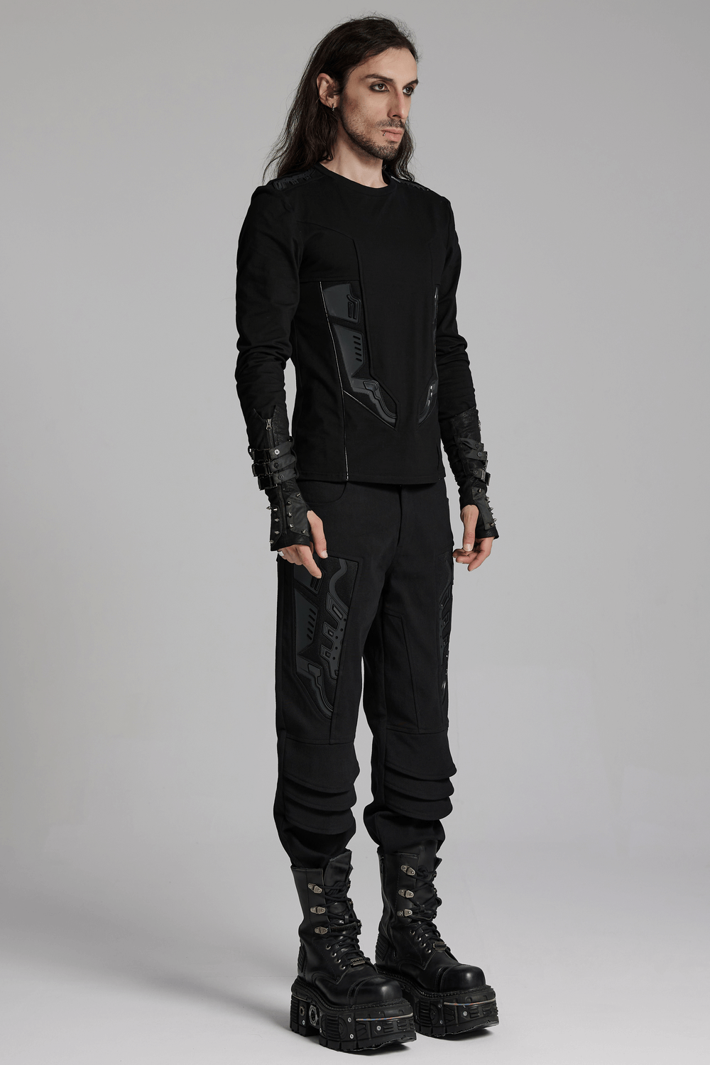 Cyberpunk-inspired black sweatshirt with armor details, paired with black pants and bold boots for a futuristic look.