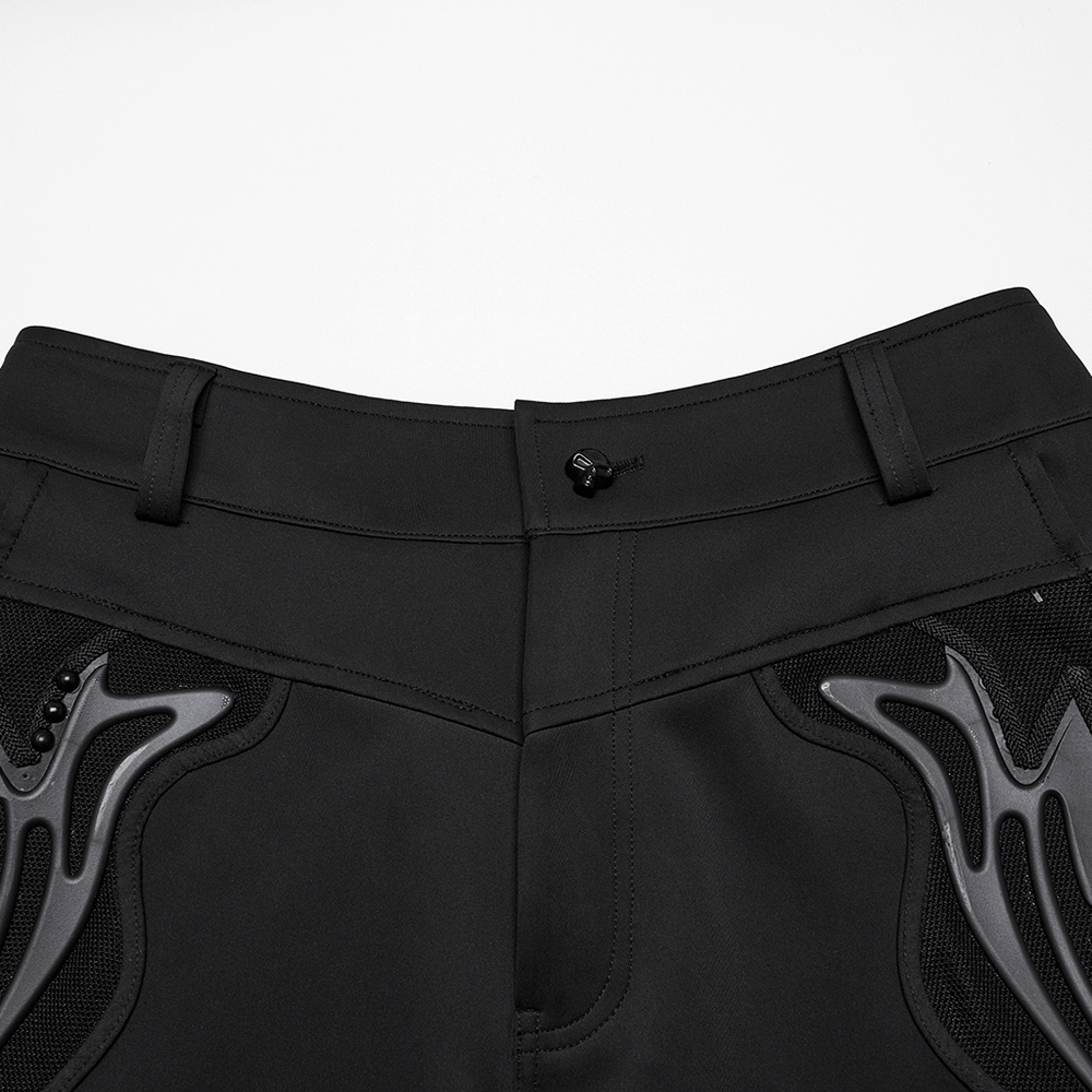 Close-up of cyberpunk knitted pants featuring riveted design and sleek black fabric with mesh pocket details.