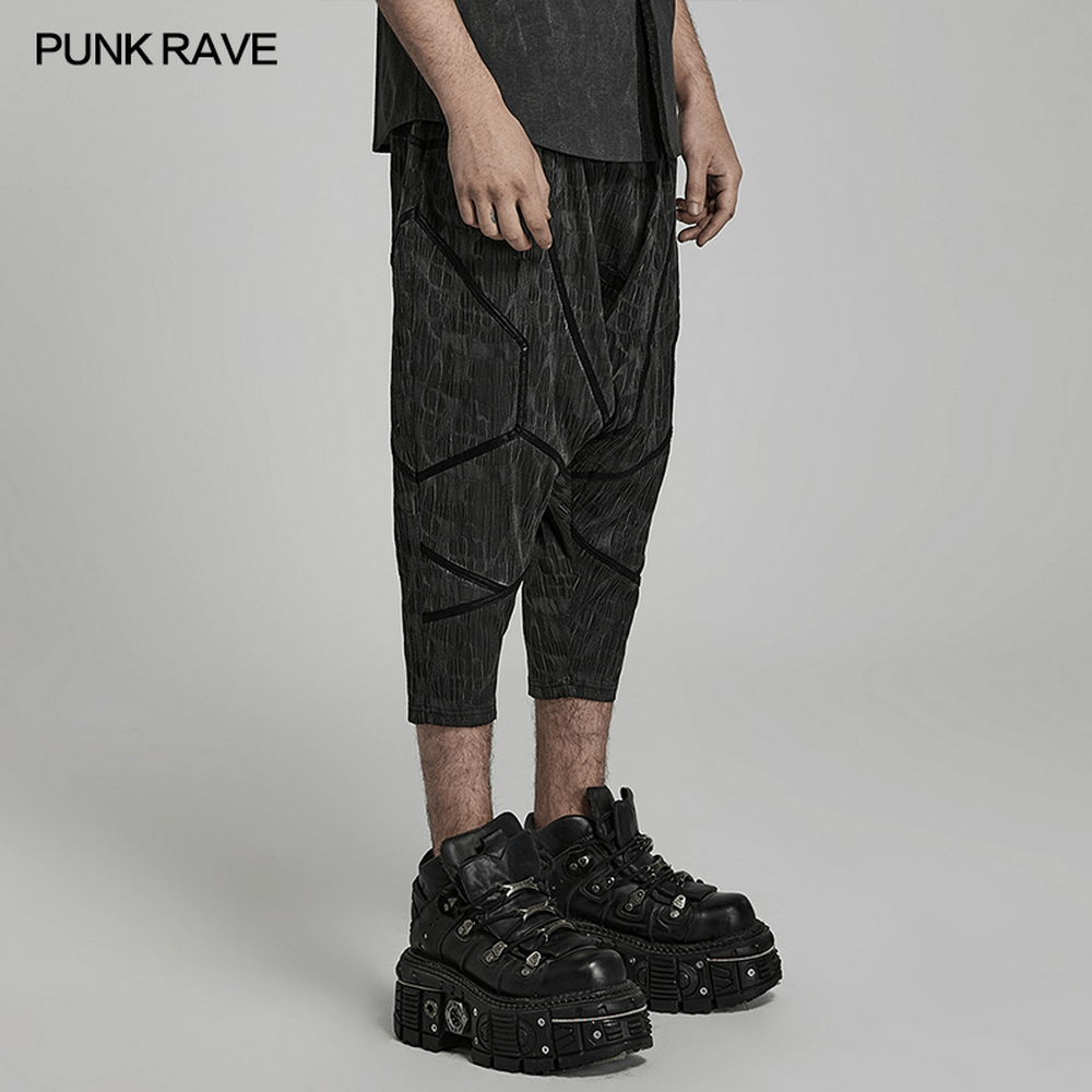 Cyberpunk men's snake texture cropped trousers with drop-crotch style, paired with edgy chunky boots.
