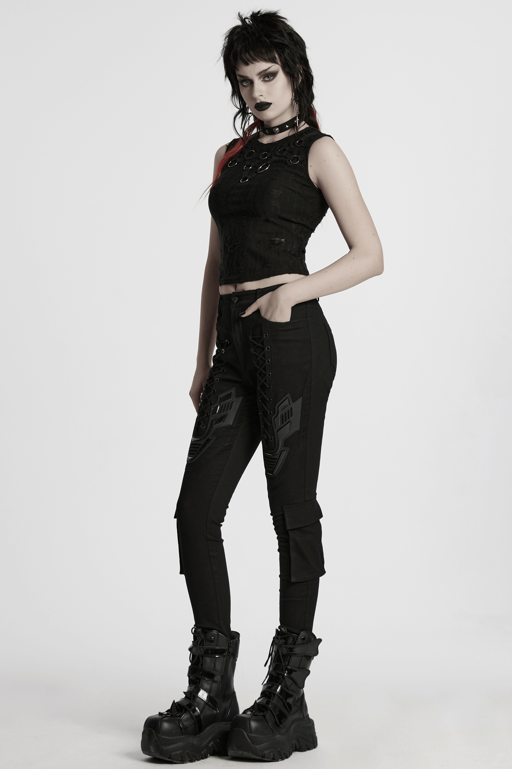 Model wearing Cyberpunk tight trousers with armor patch, eyelet drawstrings, and combat boots.