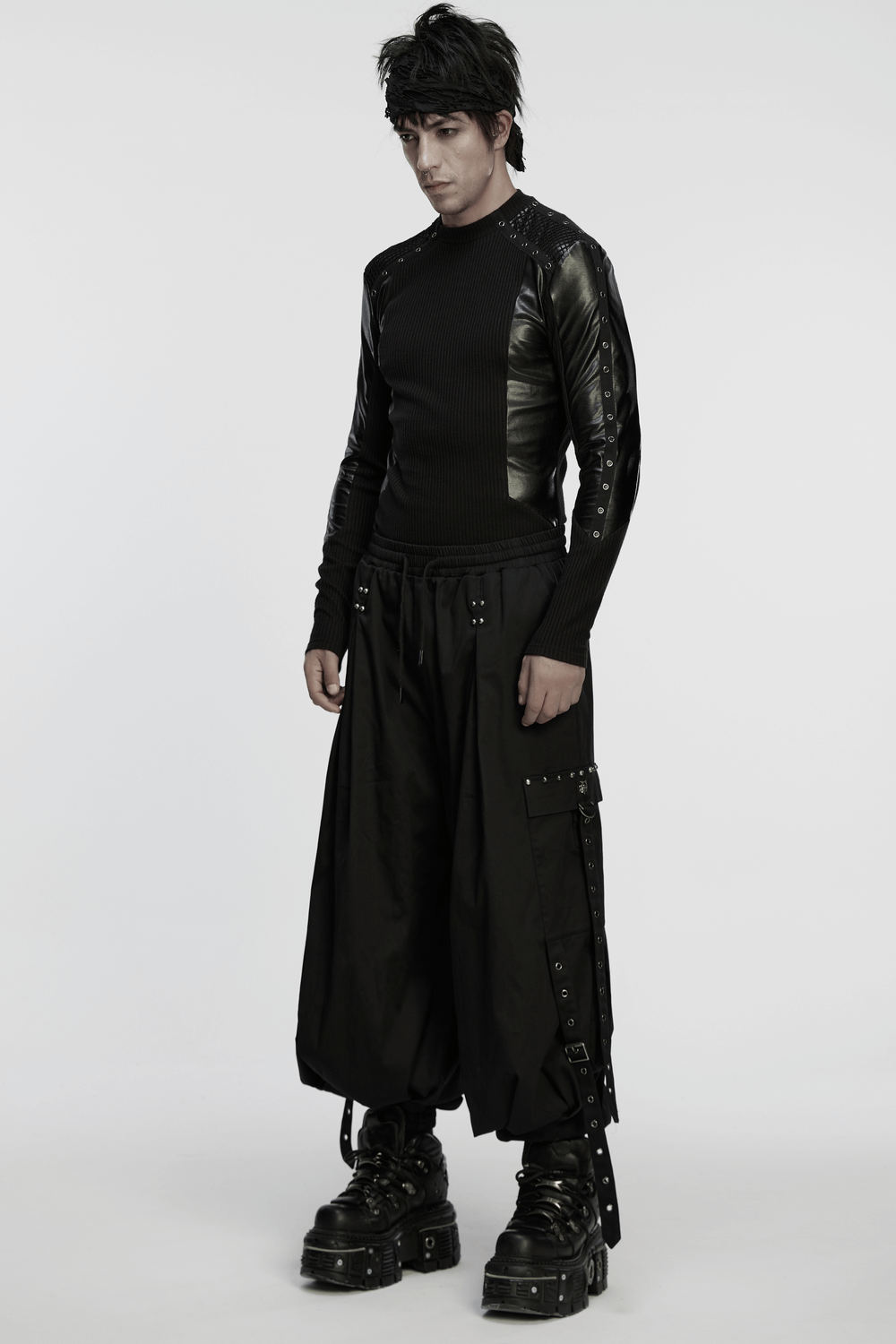 Model wearing a Cyberpunk Top with Metal Studs and Mesh Accents, styled with edgy black pants and chunky boots.