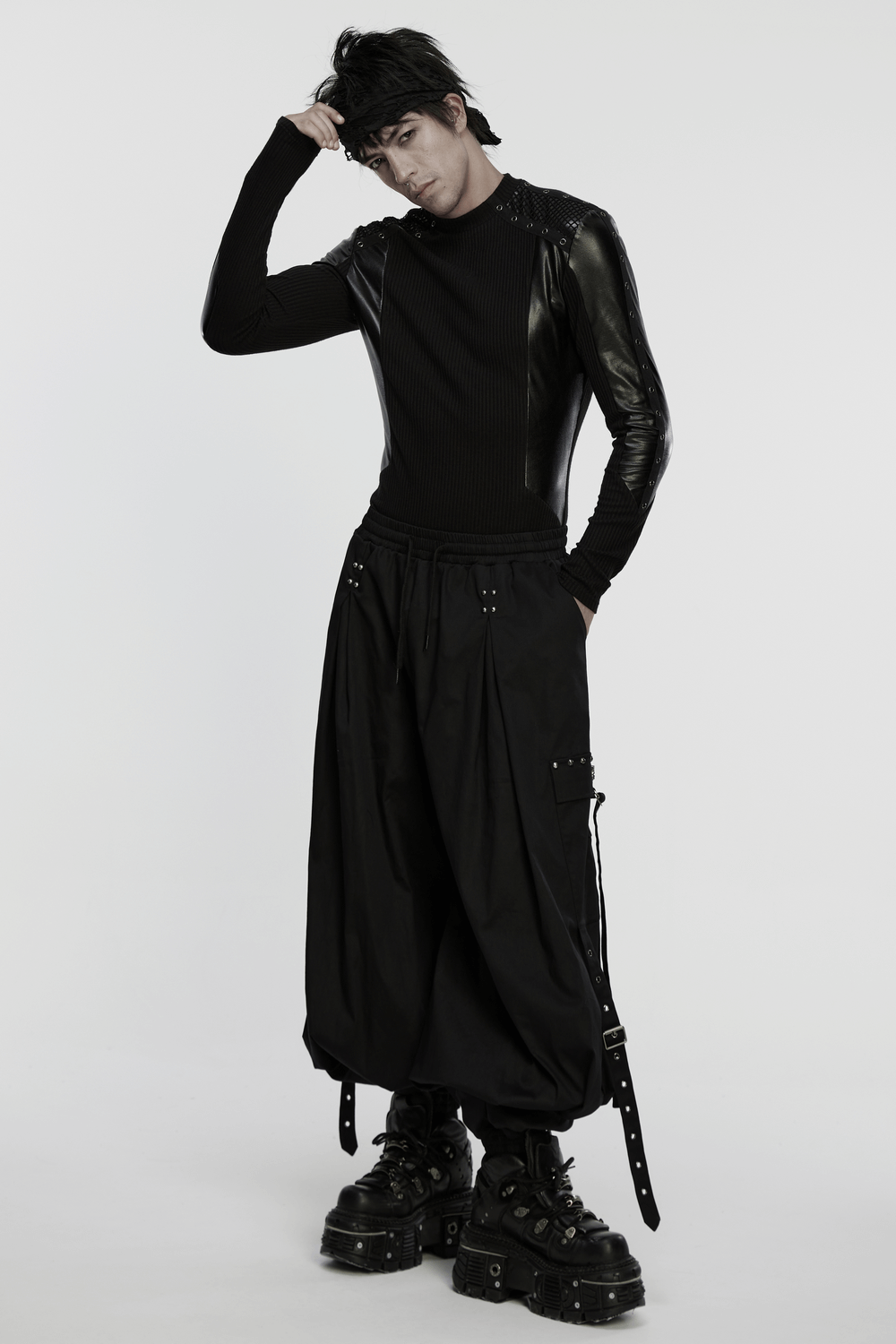 Cyberpunk Top with Metal Studs and Mesh Accents worn by a model, showcasing edgy style with bold black fashion.