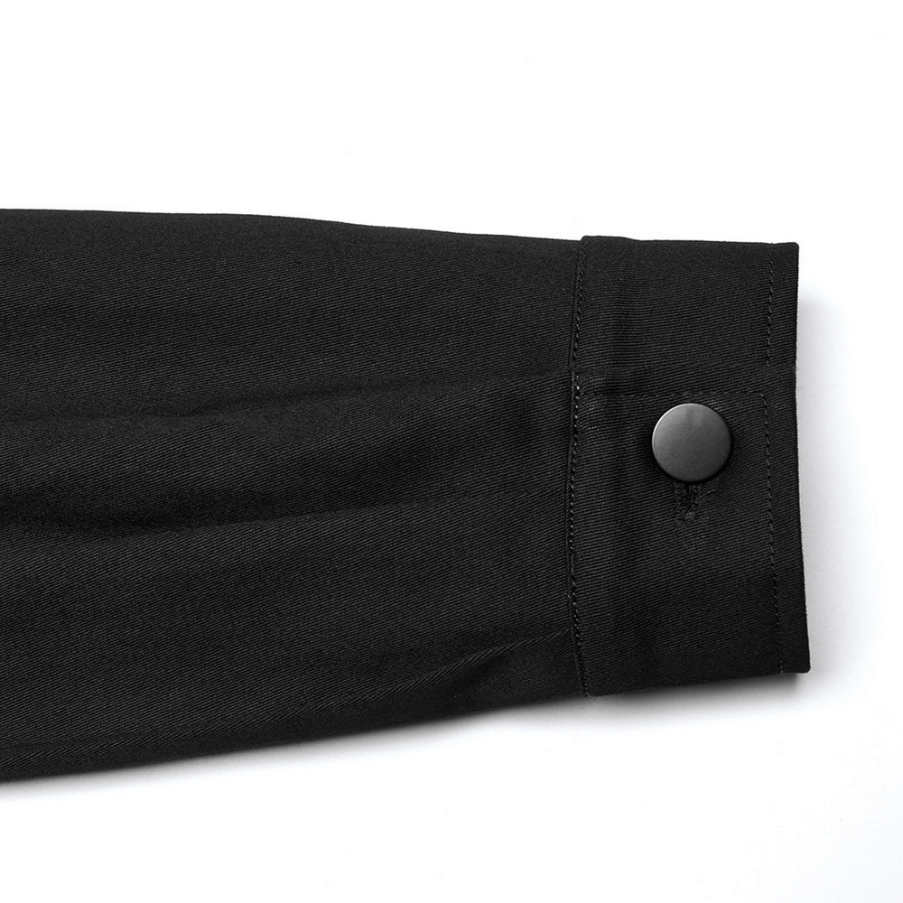 Close-up of black twill shirt cuff with button detail, showcasing sleek design and futuristic style.