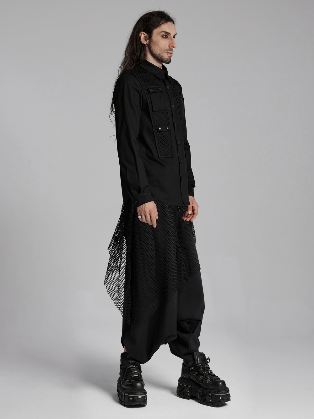 Futuristic black twill shirt with mesh panels and 3D pockets, paired with stylish platform boots in a modern cyberpunk look.