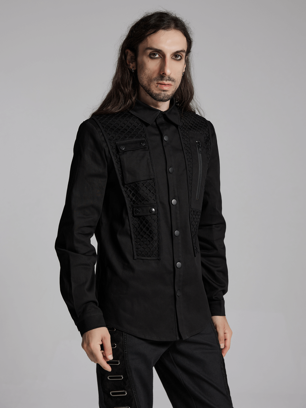 Cyberpunk twill shirt with mesh panels, 3D pockets, zipper, and metal buckles on a male model. Stylish futuristic look.